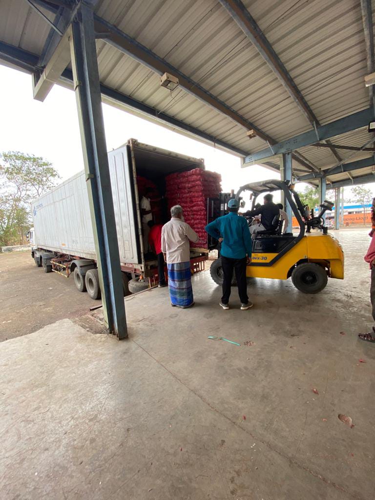 Produce cartons being moved into a transport vehicle